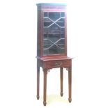 A LATE VICTORIAN MAHOGANY GLAZED CABINET with dentil frieze above astragal glazed door, on stand