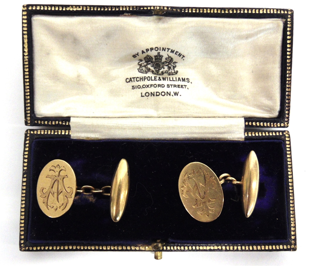 A PAIR OF CUFFLINKS stamped '18ct', the oval monogrammed panels with chain link connectors to a