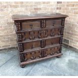 AN OAK CHEST OF FOUR LONG DRAWERS in 17th century style, with split bobbin and geometric moulded