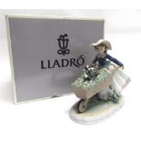 A LLADRO FIGURAL GROUP 'BARROW OF FUN' no. 5460, modelled as a young girl pushing a wheelbarrow of