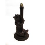 A BLACK FOREST FIGURAL TABLE LAMP modelled as a seated bear on circular base, 36.5cm high overall