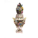 A CONTINENTAL PORCELAIN LIDDED VASE with pierced decoration, female mask handles and profusely