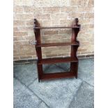 A MAHOGANY FOUR TIER HANGING SHELF 59cm wide 49cm high, together with a towel rail