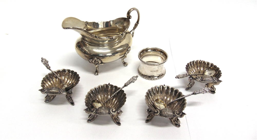 A SILVER CREAM JUG by C.C. Pilling, London 1903, of oval form, on three supports; a set of four