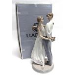 A LLADRO FIGURAL GROUP 'LOVES LITTLE SURPRISES/ REGALO SORPRESO' no. 6746, modelled as a young