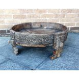 AN ETHNIC TRAY TOP CIRCULAR TABLE with carved decoration, 70cm diameter 20cm high