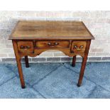 A GEORGE III MAHOGANY LOWBOY fitted with three drawers above shaped apron on square chamfered