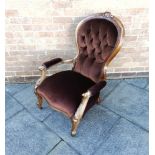 A VICTORIAN CARVED WALNUT FRAMED OPEN ARMCHAIR with button upholstery, on cabriole supports