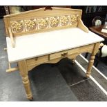 A PITCH PINE MARBLE TOP WASHSTAND with tiled splashback, with drawer to frieze and rail to each