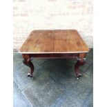 A VICTORIAN MAHOGANY EXTENDING DINING TABLE on cabriole supports with carved foliate decoration