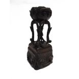 A CARVED HARDWOOD FIGURAL STAND 25cm high