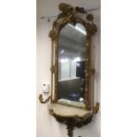 A PAIR OF GILT GESSO GIRANDOLES the arched mirrors framed by foliate motifs and surmounted by