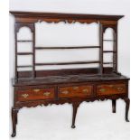 AN 18TH CENTURY OAK DRESSER the delft rack with moulded cornice and fretted frieze, three mahogany