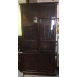 A 19TH CENTURY MAHOGANY CABINET the upper section with moulded cornice above pair of glazed doors,