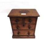 AN OAK MINIATURE CHEST OF DRAWERS late 19th or early 20th century, probably an apprentice piece,