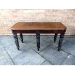 A MAHOGANY SIDE TABLE the rectangular top with moulded edge, supported on five carved and spirally