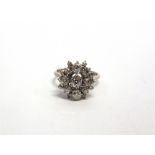 A SEVENTEEN STONE DIAMOND CLUSTER RING the yellow mount unmarked, the central diamond of