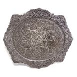 A LARGE AND ORNATE INDIAN METAL TRAY heavily chased with flora, similarly decorated pierced shaped