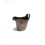 A GEORGIAN SILVER HELMET SHAPED CREAM JUG makers marks worn, London 1803, height to top of handle