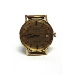 ACCURIST, A GENTLEMAN'S 9 CARAT GOLD MECHANICAL WRIST WATCH the gold coloured round dial with gilt