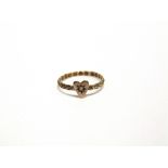 A LATE VICTORIAN 9 CARAT GOLD LOVERS HEART RING Birmingham 1898, the motif star set with a seed