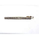 A DIAMOND LINE BROOCH the slightly graduated sixteen old brilliant cuts totalling approximately 2.