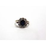 A DIAMOND AND SAPPHIRE CLUSTER RING the white mount unmarked, the oval cut stone measuring