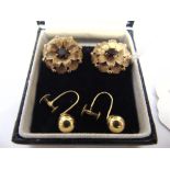 A PAIR OF GARNET SET 9 CARAT GOLD EARCLIPS London 1964, the flower head mount centred by a round cut