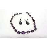 AN AMETHYST RIVIERE NECKLACE the twenty-three graduated oval cuts collet set in unmarked silver