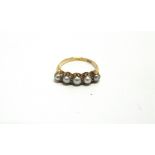 A FIVE STONE PEARL RING stamped '18ct', the pearls (untested and unwarranted) of a greyish hue,