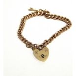 A 9 CARAT GOLD BRACELET of solid curb links, to a padlock clasp and with a key charm, 22.1g gross