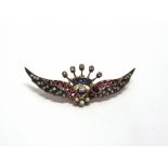 A DIAMOND, RUBY, SAPPHIRE AND SPLIT PEARL SET CROWNED WINGS BROOCH circa 1900, central diamond