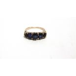 A FIVE STONE SAPPHIRE RING the graduated oval cuts to a carved head mount, numbered 171, finger size