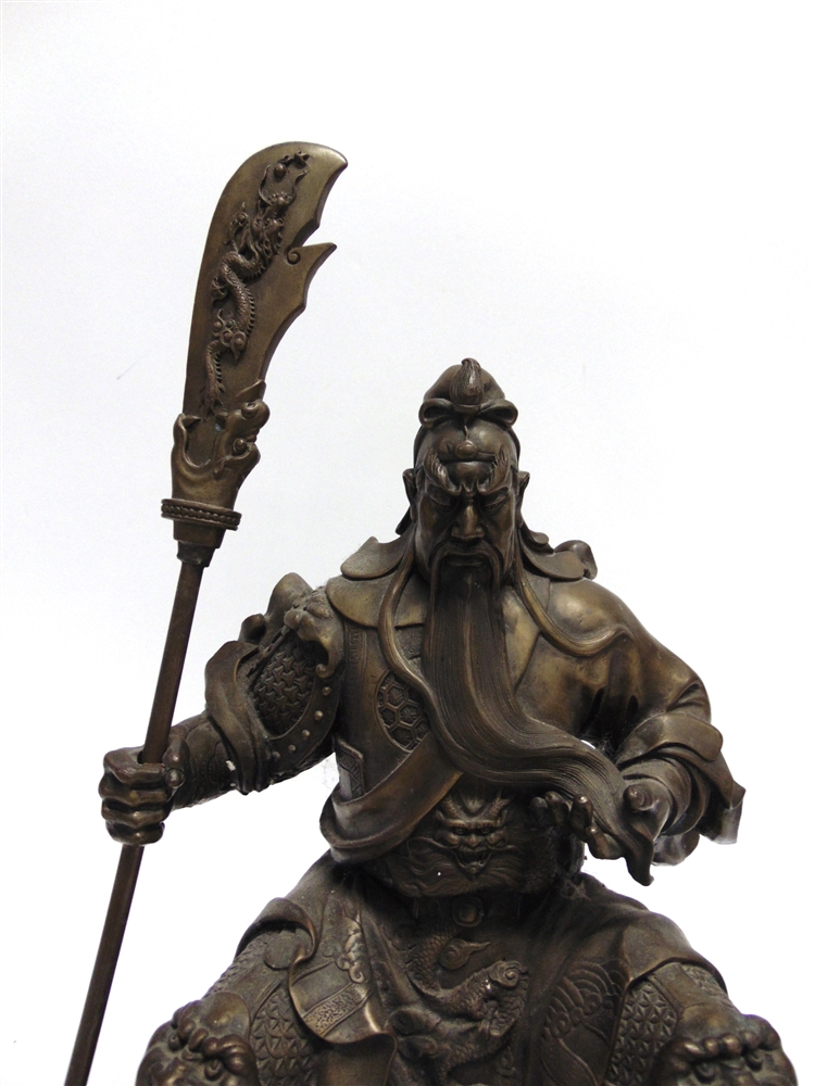 A HEAVY BRONZED METAL FIGURE modelled as a Chinese warrior, seated and holding a pole arm, 51cm - Image 2 of 3