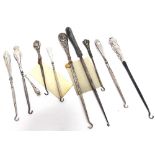 A COLLECTION OF TEN SILVER AND SILVER COLOURED BUTTON HOOKS