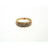 A LATE VICTORIAN FIVE STONE DIAMOND RING stamped '18', the graduated old cuts totalling