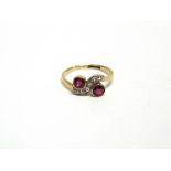 A DIAMOND AND SYNTHETIC RUBY RING stamped '18ct & Plat', the two round cut synthetics to a cross