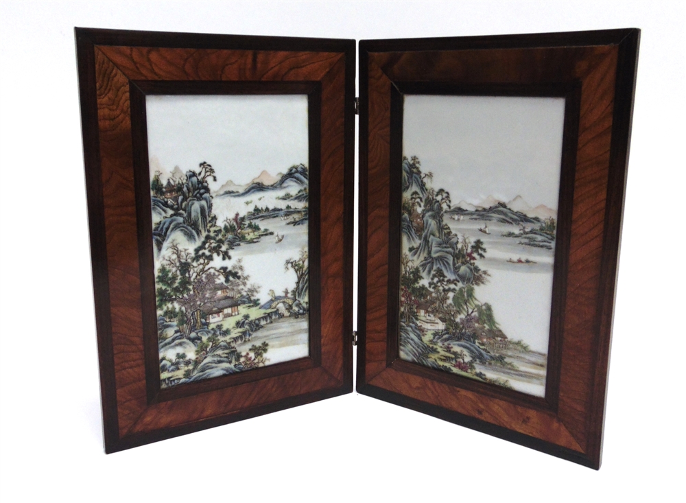 A PAIR OF CHINESE PORCELAIN PLAQUES enamelled with landscape scenes, held in a wooden frame, each