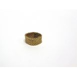 HERMES, A GOLD MESH WEAVE FLEXIBLE RING with a engraved tag 'Hermes, Paris' over the number '