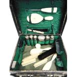 A TRAVELLING TOILET SET with six silver mounted glass bottles, an ivory paper knife; an ivory hair