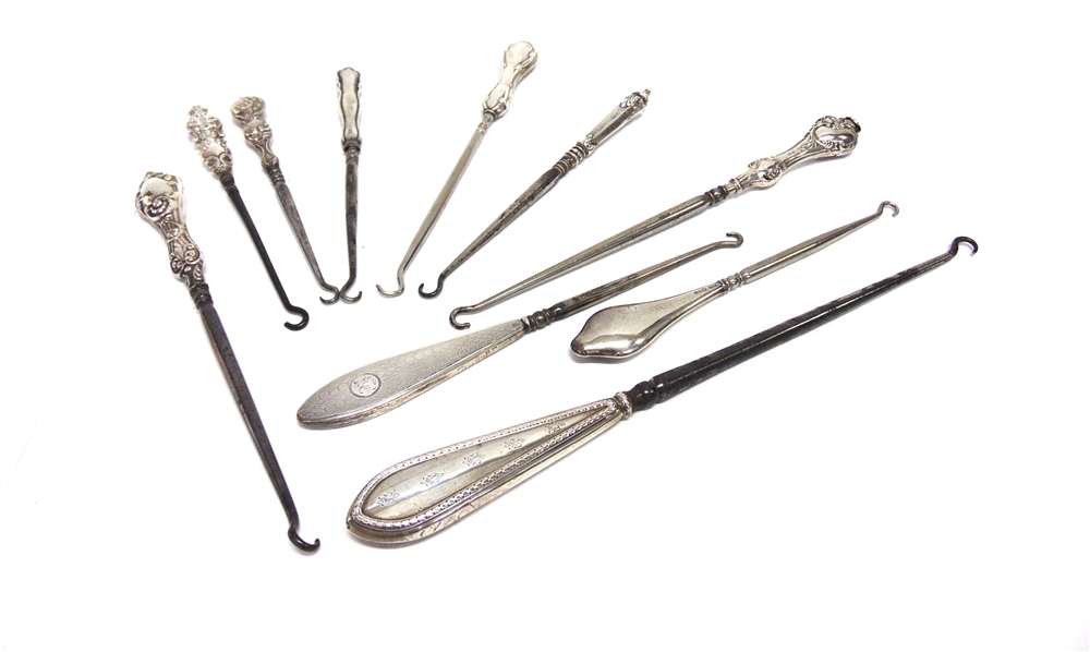 A COLLECTION OF TEN SILVER AND SILVER COLOURED BUTTON HOOKS