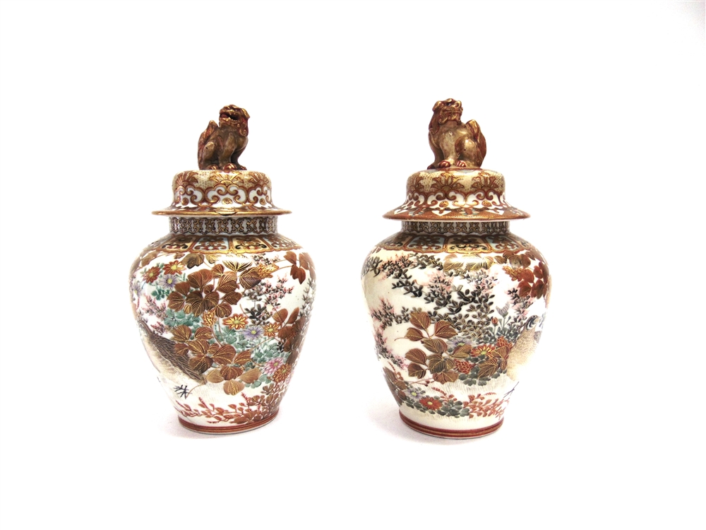 A PAIR OF JAPANESE KUTANI LIDDED VASES the finials modelled as dogs of Fo, six character marks to