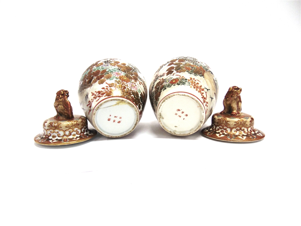 A PAIR OF JAPANESE KUTANI LIDDED VASES the finials modelled as dogs of Fo, six character marks to - Image 2 of 2