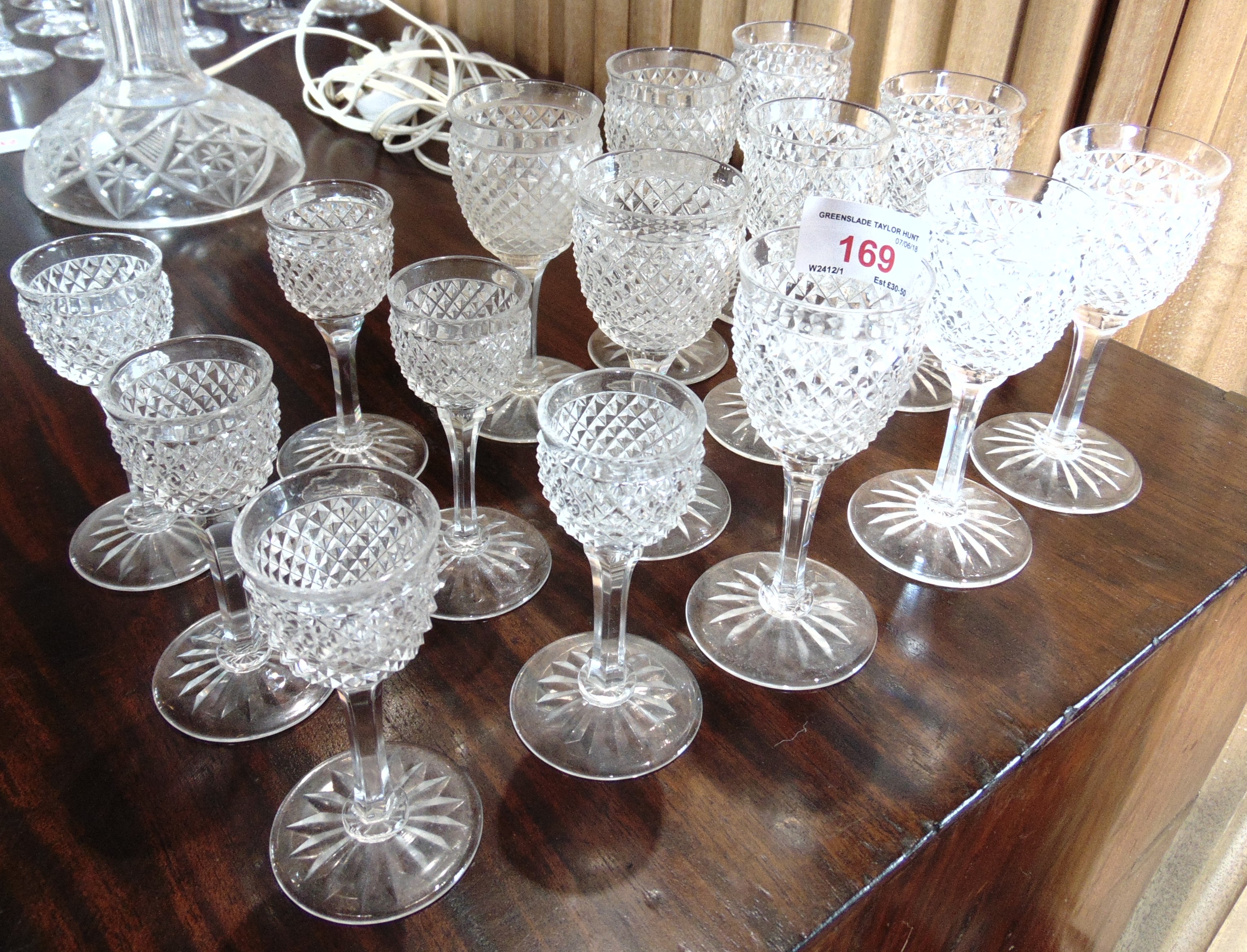 NINE MATCHING CUT GLASS SHERRY GLASSES 12cm high, star cut bases; and six matching liqueur glasses