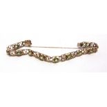 A MURLE BENNETT & CO PERIDOT BRACELET circa 1910, the alternating rectangular and square open panels