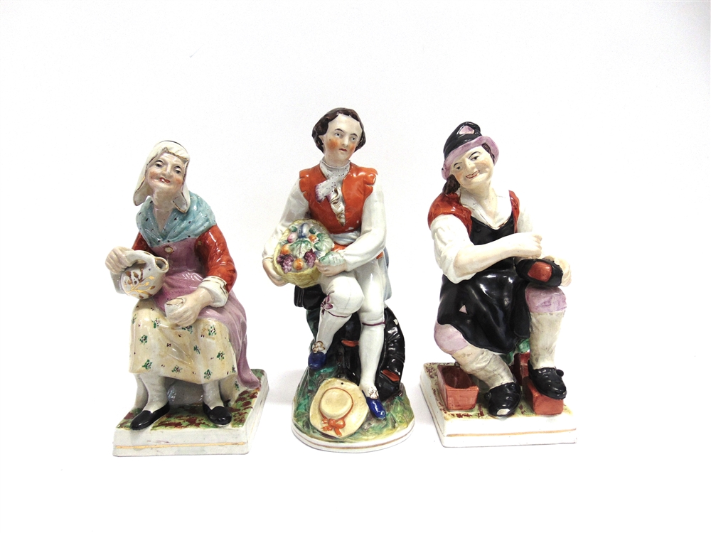 A PAIR OF STAFFORDSHIRE FIGURES the cobbler and his wife, together with another similar