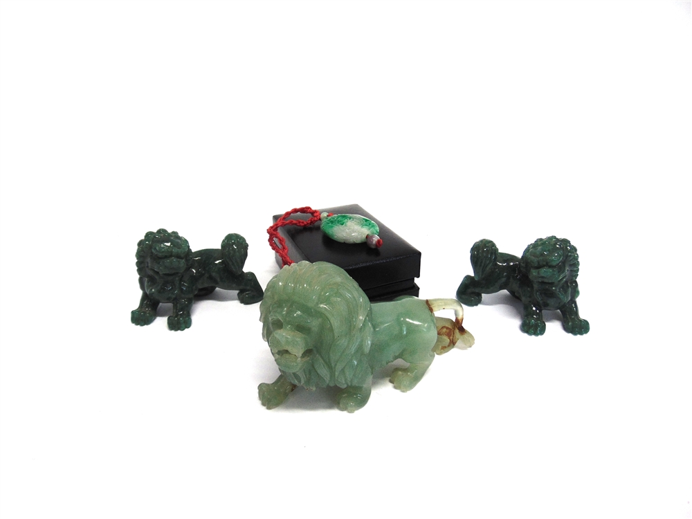 A CARVED JADE FIGURE OF A LION 12cm long, similar pair of Dogs of Fo, and a pendant