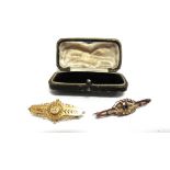 A GOLD BROOCH stamped '15ct', circa 1900, 4.5g; with a paste set brooch, tagged '9ct', 2.1g gross;