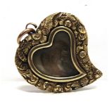 A LATE VICTORIA MOURNING LOCKET of heart shape with a glazed centre containing hair, foliate