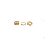 AN 18 CARAT GOLD PATTERNED WEDDING RING and two plain 18 carat gold wedding rings; 15g gross